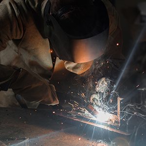 Manufacture Worker Welding Metal With Sparks at Factory