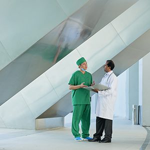 Two doctors standing at the hospital and discussing work