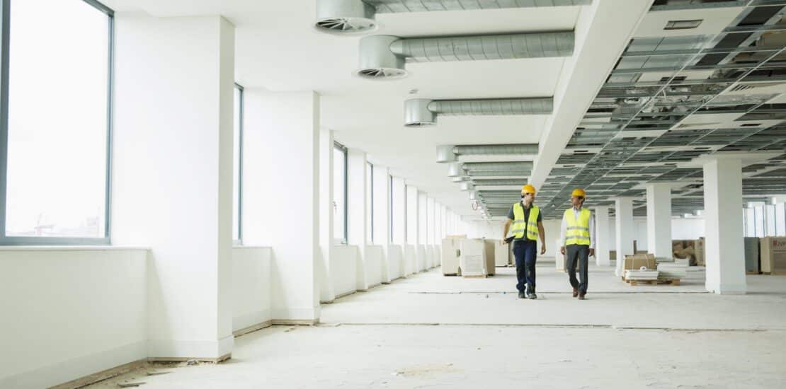 two safety professionals walking in a commercial building