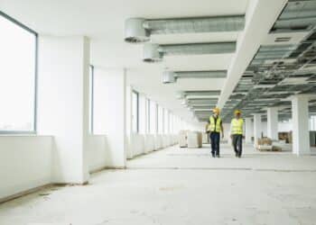 two safety professionals walking in a commercial building