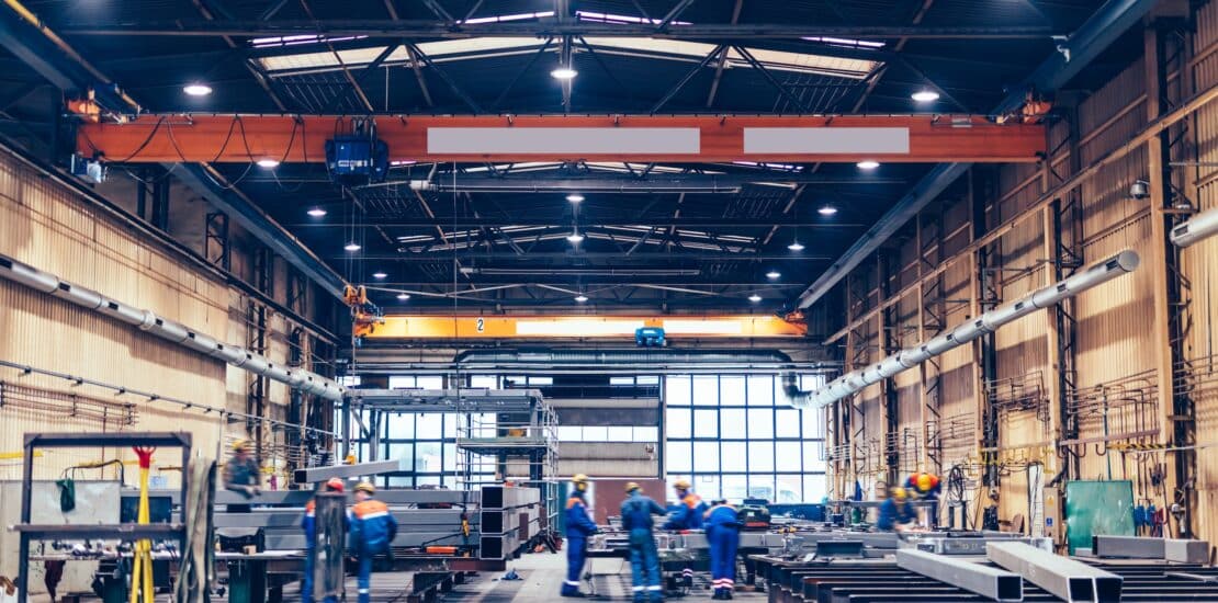 workers in large manufacturing building