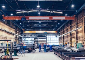 workers in large manufacturing building