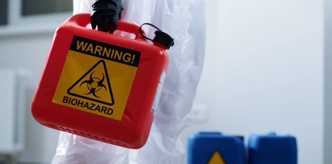 biohazard container being carried by worker